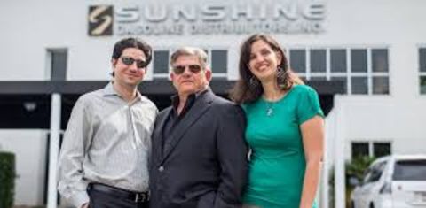 Maximo Alvarez poses in front of the Sunshine Gasoline with family.